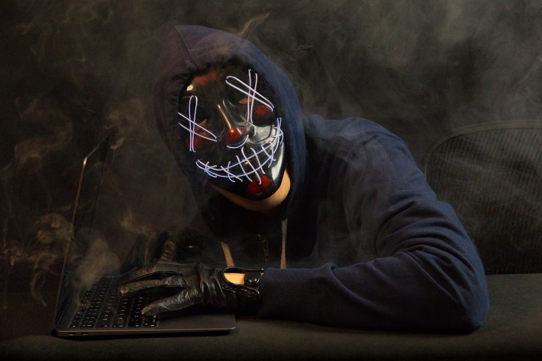 Ethical hacker performing penetration testing on a network using a laptop in a dark-lit security lab