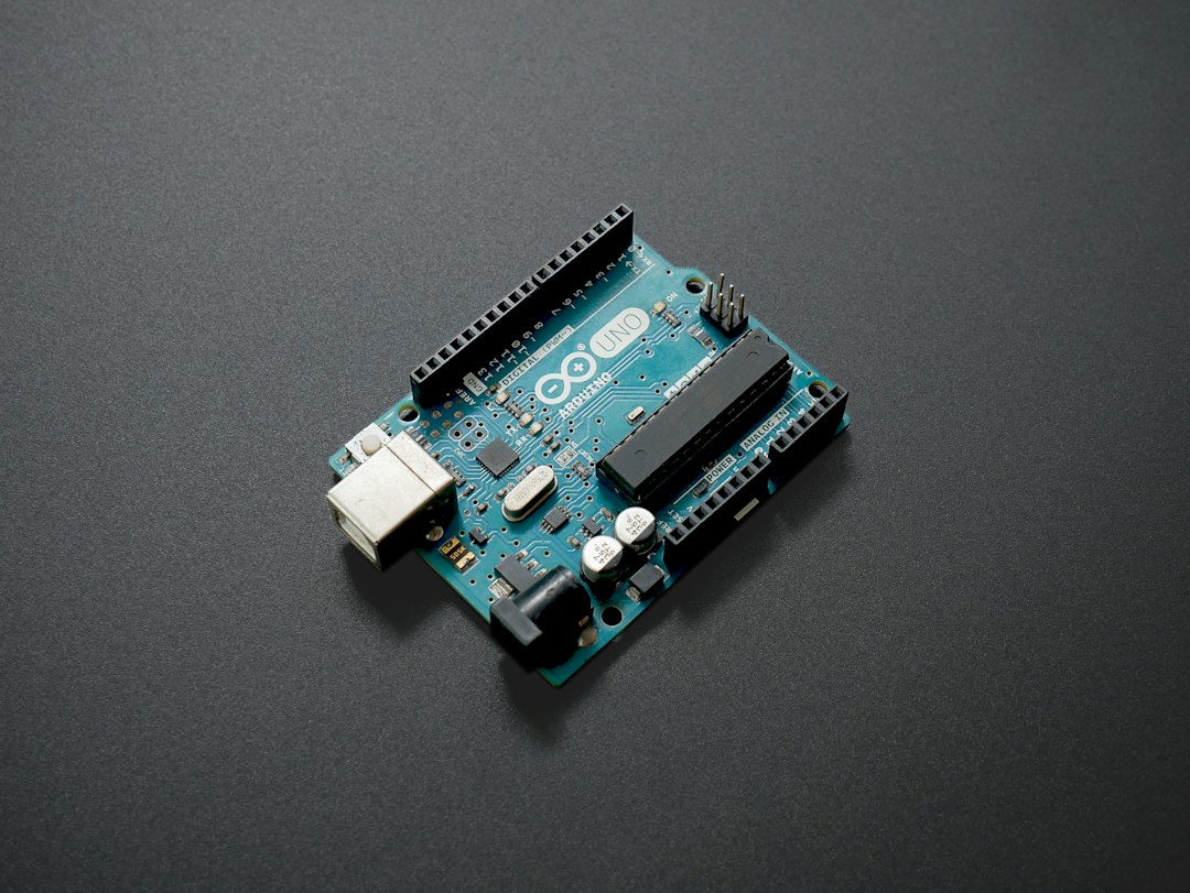 Arduino Uno, Raspberry Pi 4, and ESP32 development boards side by side comparison on a white surface
