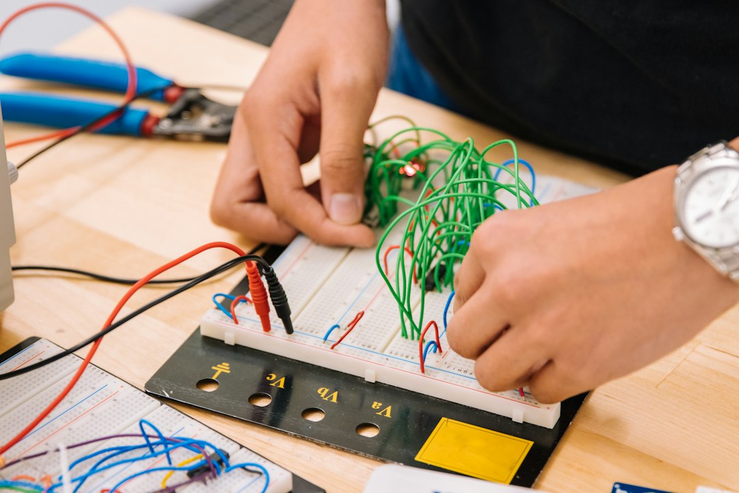Embedded systems engineer programming an ESP32-based IoT sensor device on a professional electronics workbench
