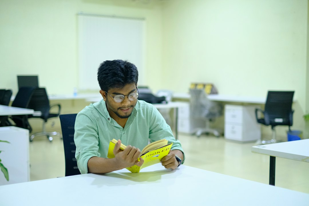 finance professional reviewing CFA FRM CPA exam study materials at desk with charts and textbooks